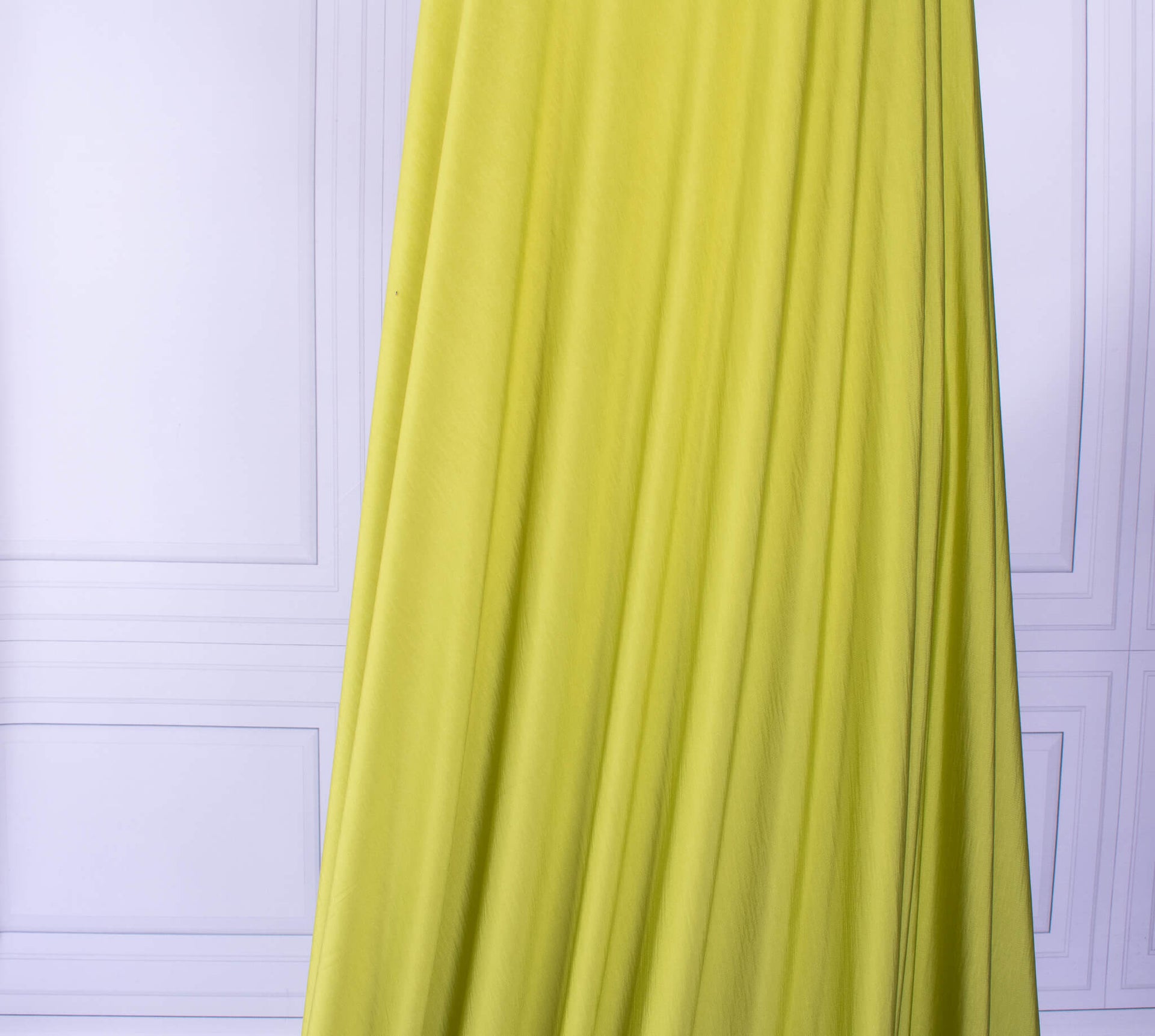  Designer citrus green 4-way stretch knit fabric draped on dressform.