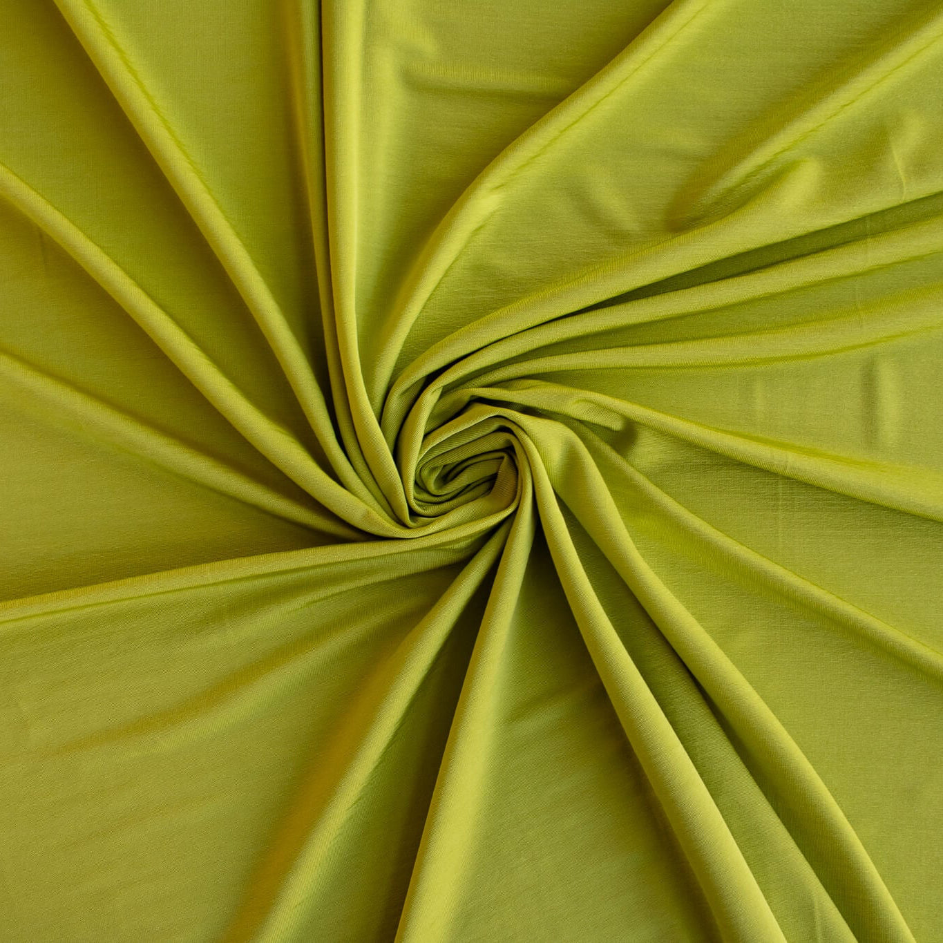 Close up of Designer citrus green 4-way stretch knit fabric.