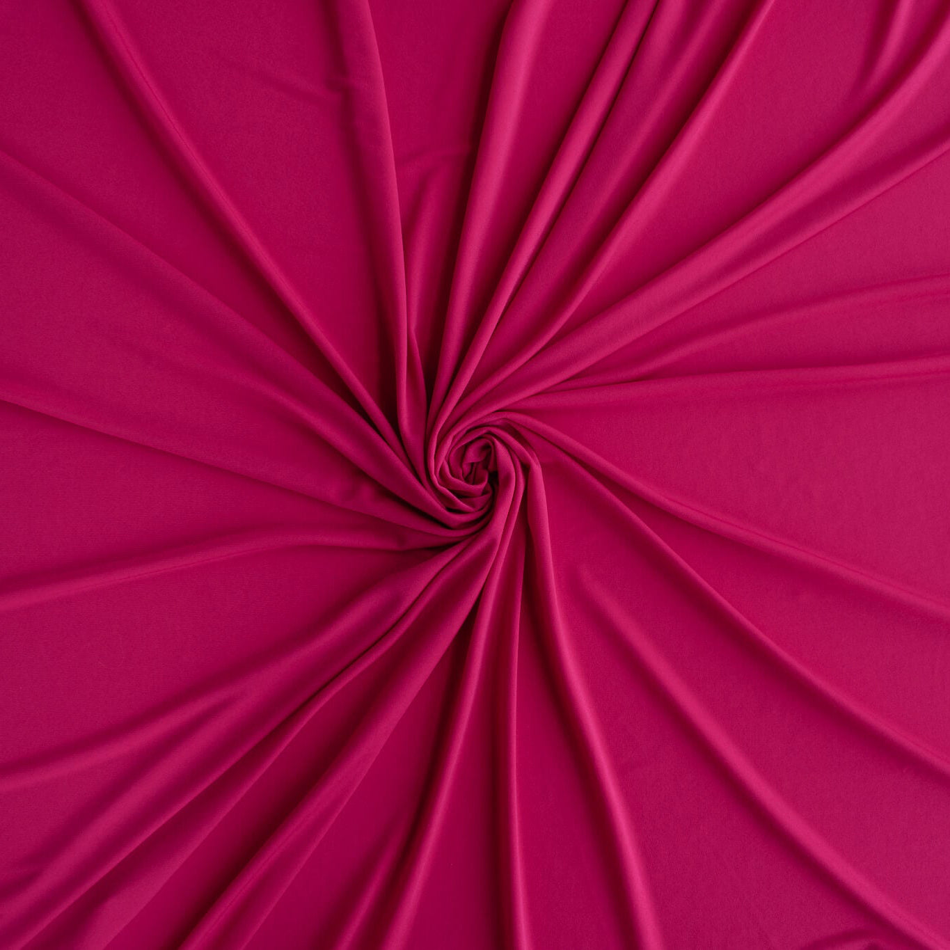 Close-up of Korean Dark Pink Polyester/Spandex ITY Knit swirled to show fullness.