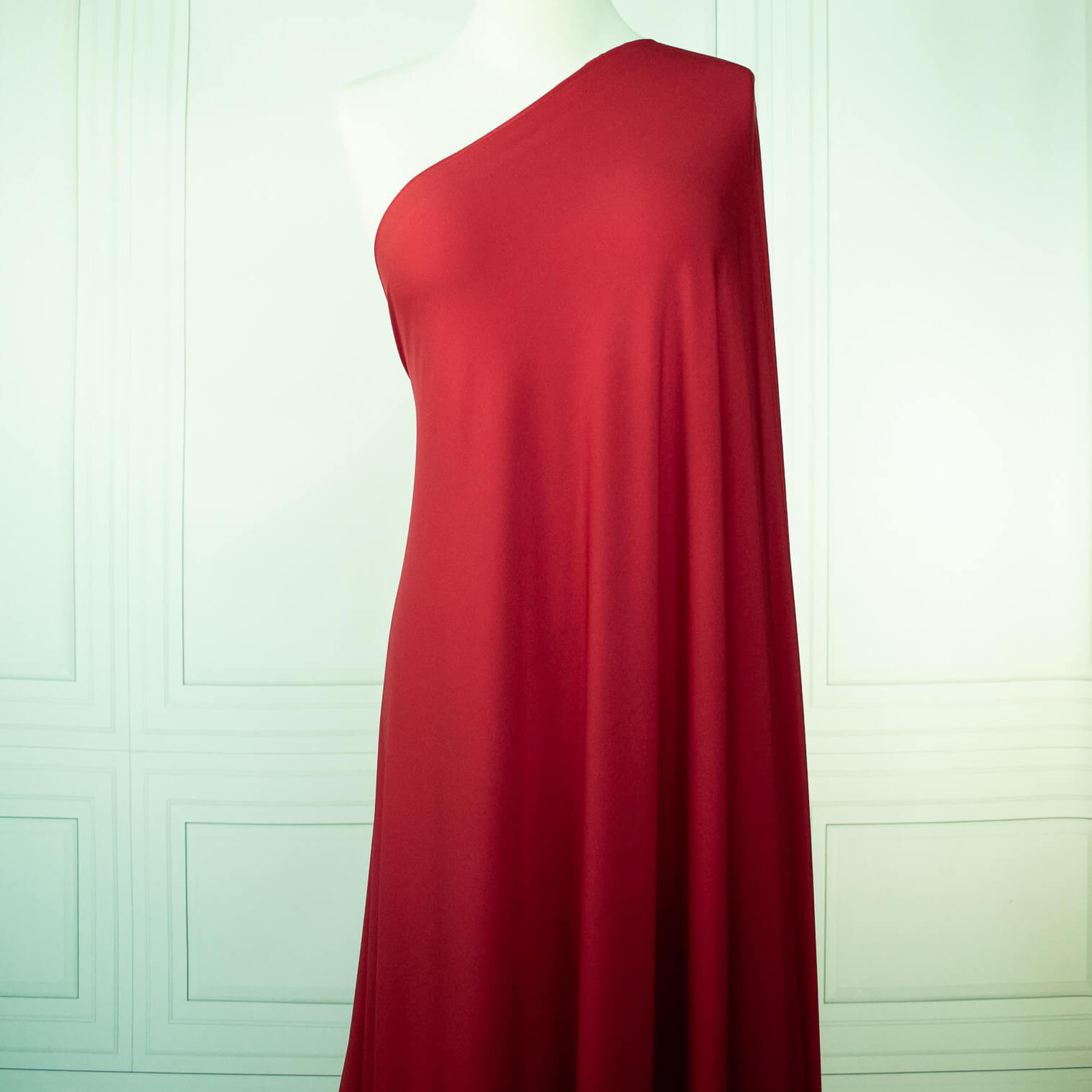 Warm red ITY jersey fabric draped on dressform