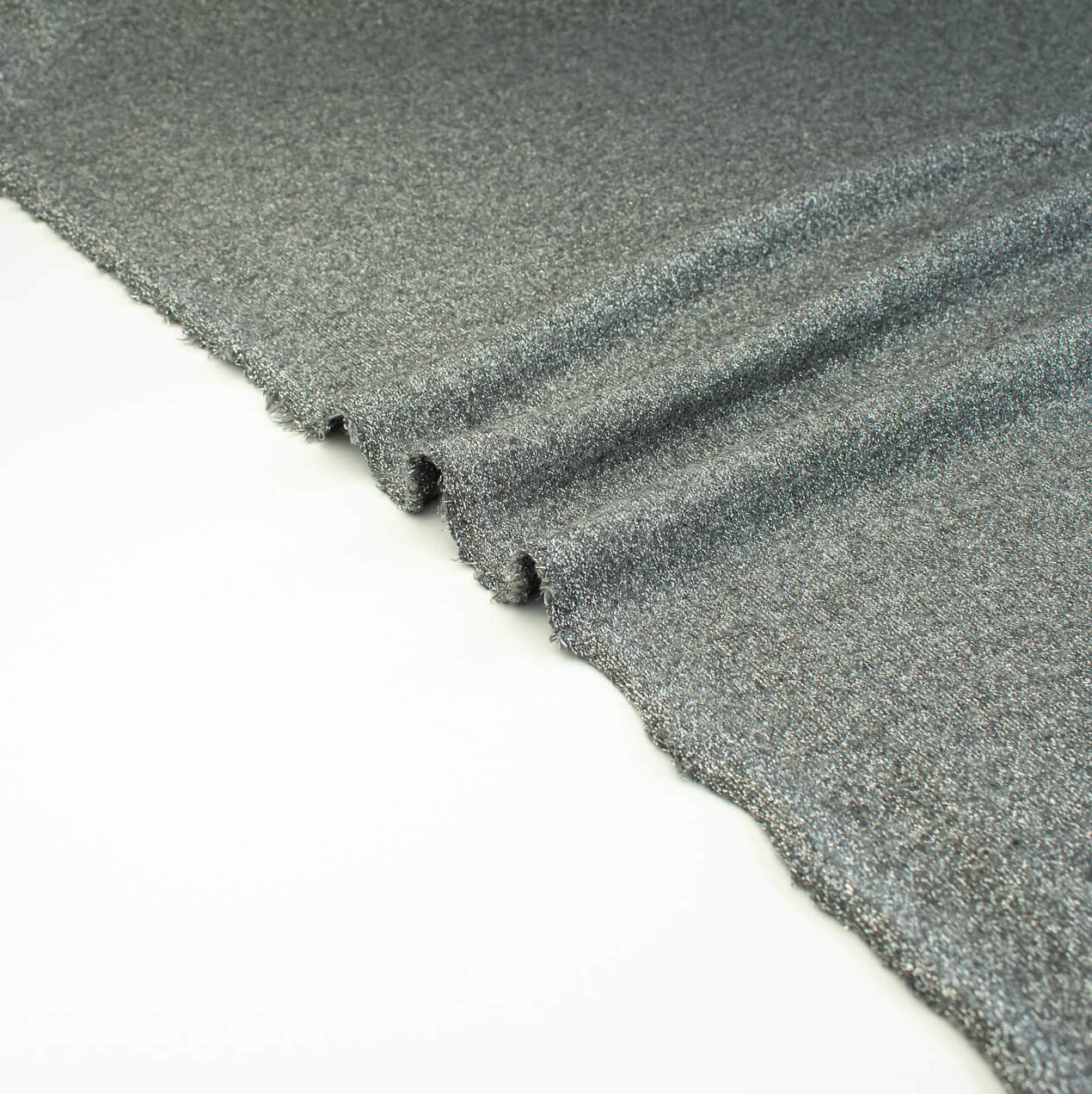 Close-up  selvedge of LA Designer Sweater Knit fabric by the yard! Create a beautiful essential in a soft gray and silver metallic rayon knit blend. 