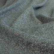 Close-up of  LA Designer Sweater Knit fabric by the yard! Create a beautiful essential in a soft gray and silver metallic rayon knit blend. 