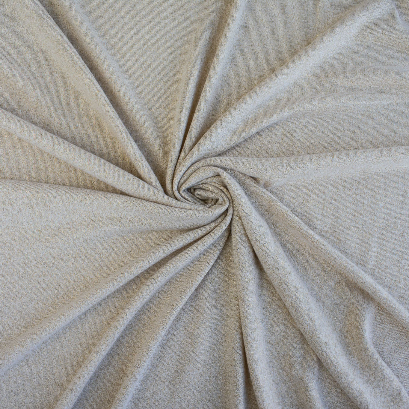 Close up of fabric fullness in a swirl of  Designer White and Gold Metallic Sweater knit fabric by the yard. 