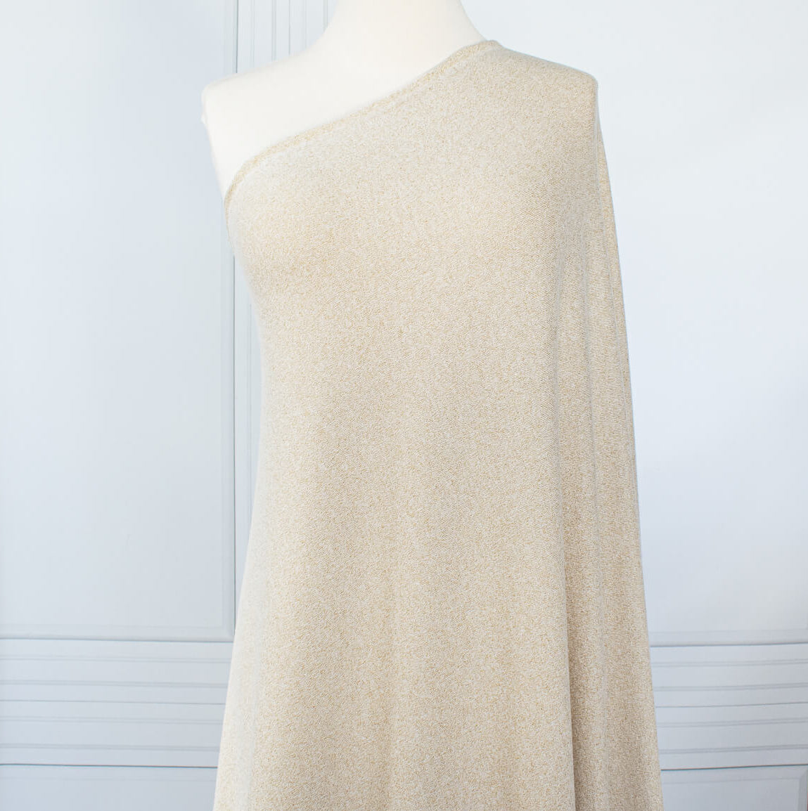 Image on dressform of  Designer White and Gold Metallic Designer Sweater knit fabric by the yard. 