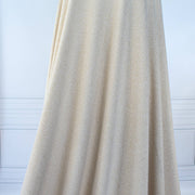 Image of fabric on dressform demonstrating drape of  Designer White and Gold Metallic Sweater knit fabric by the yard. 