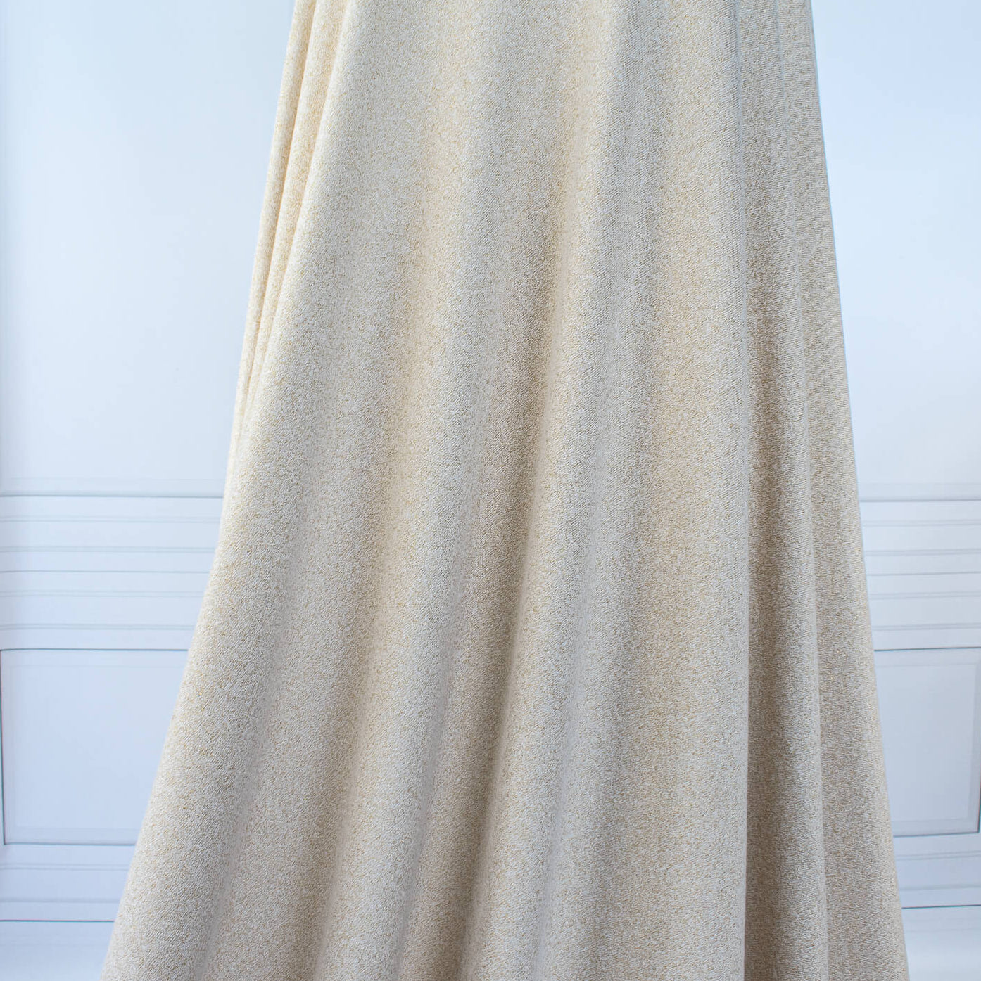 Image of fabric on dressform demonstrating drape of  Designer White and Gold Metallic Sweater knit fabric by the yard. 