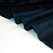 Dark blue silk twill fabric on a white background