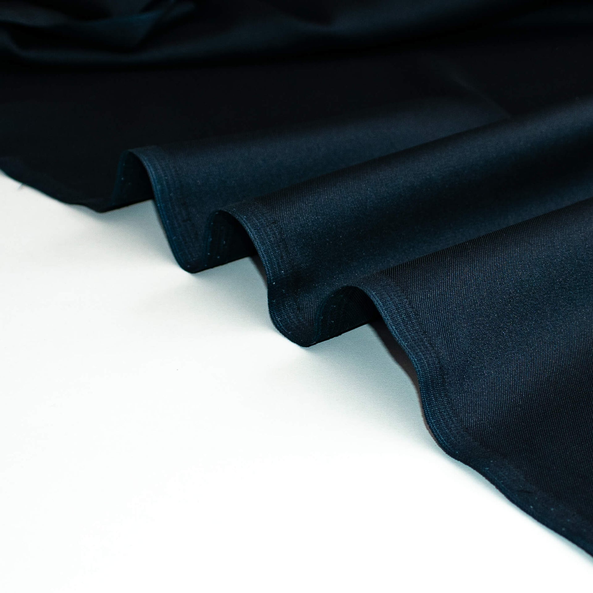 Dark blue silk twill fabric on a white background