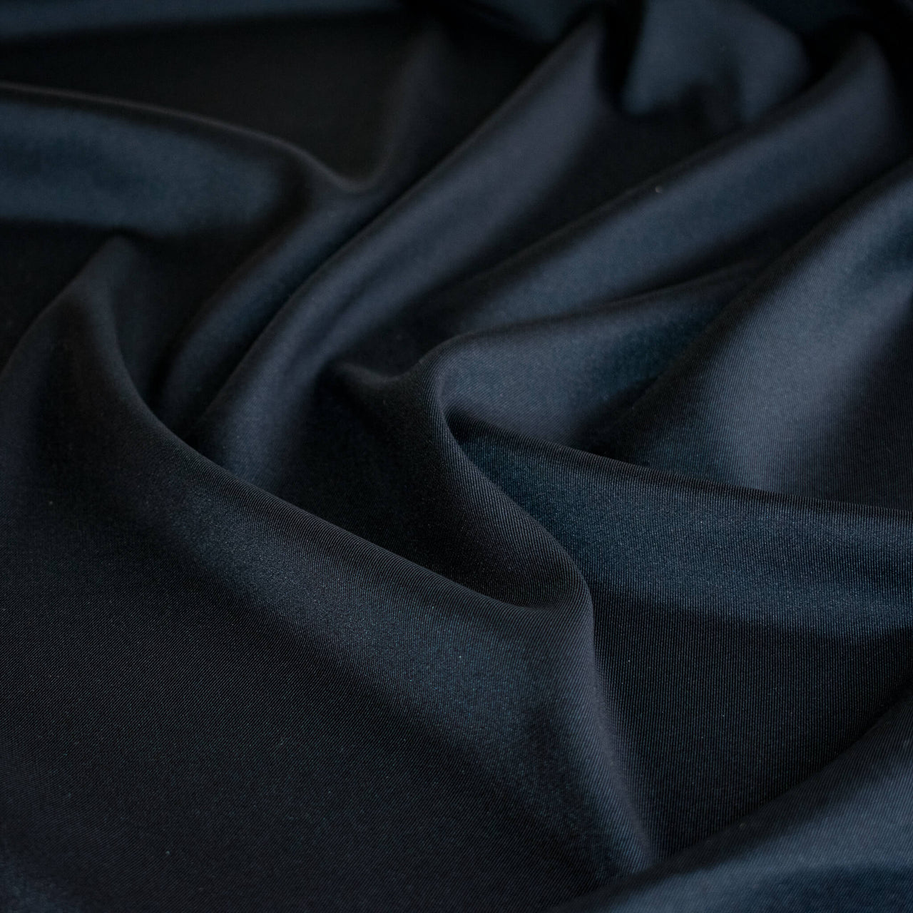 Dark blue silk twill fabric with folds
