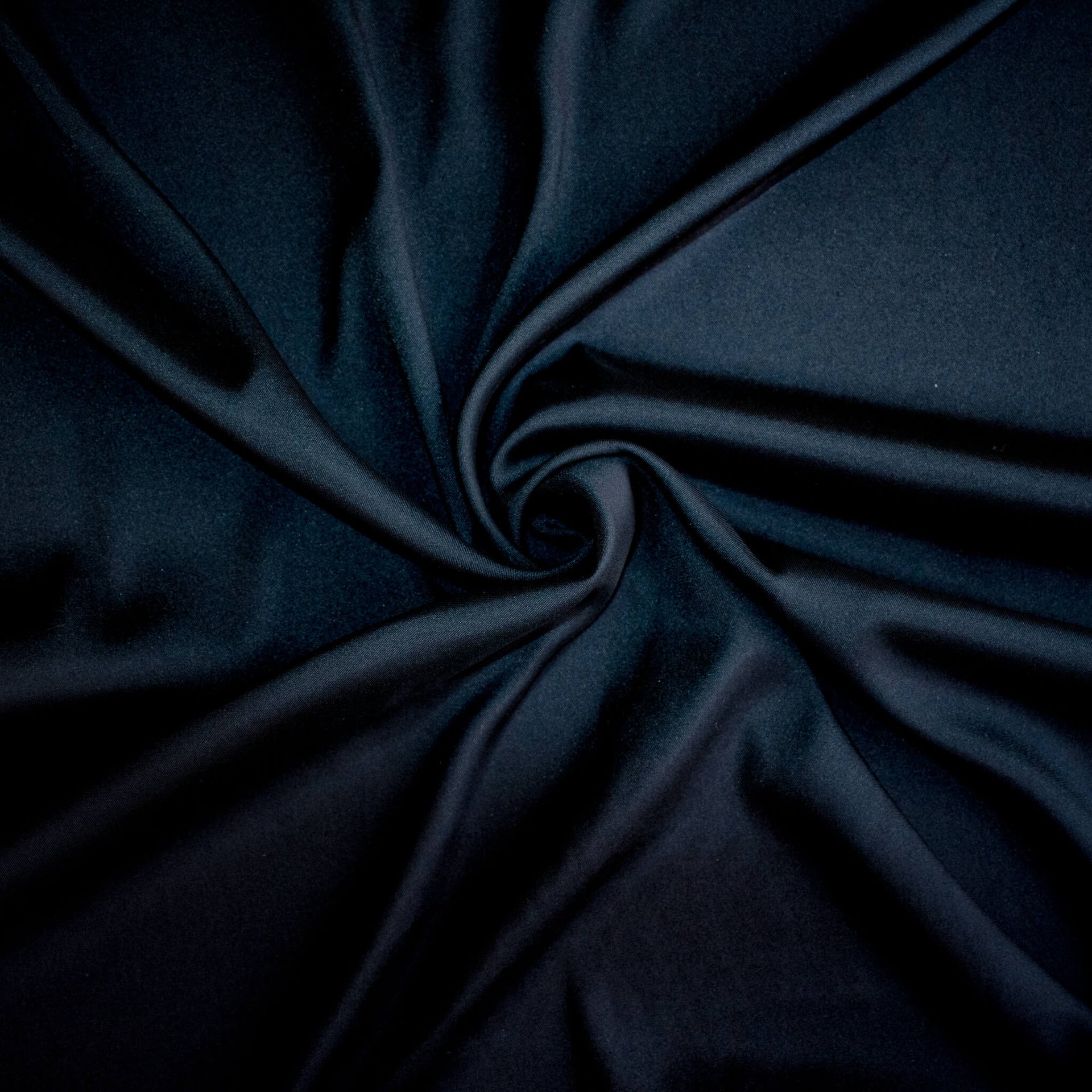 Dark blue silk twill  fabric with a swirl to demonstrate fabric body