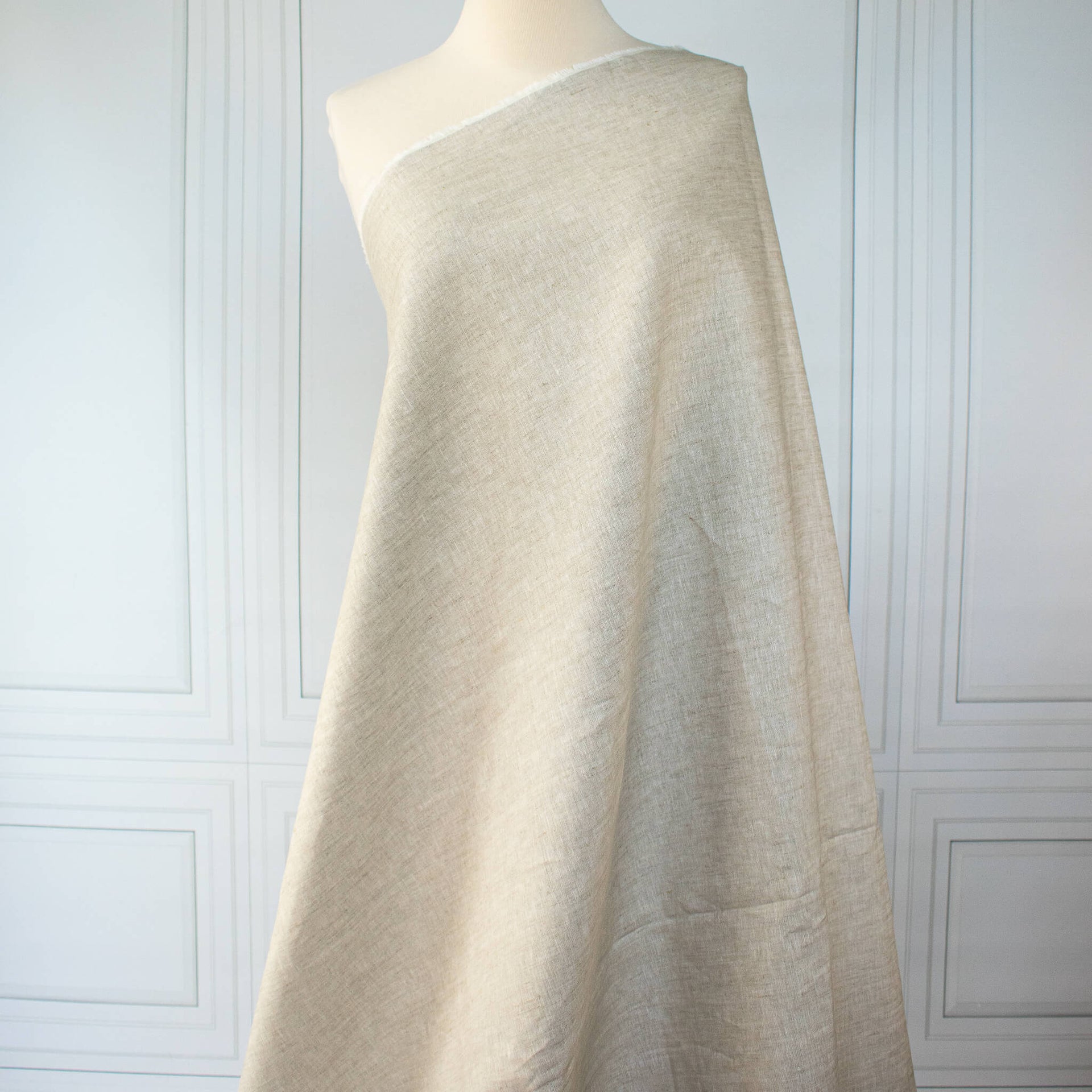  Image of tan/white 100% linen mid-weight woven fabric on dressform 