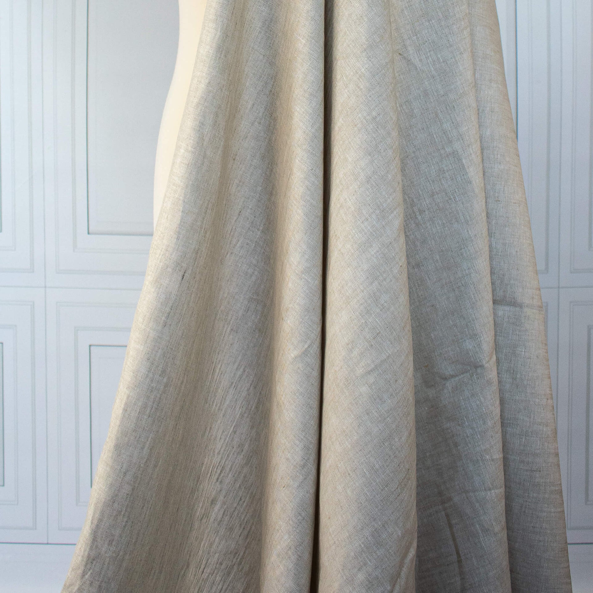  Image of tan/white 100% linen mid-weight woven fabric on dressform to demonstrate drape.