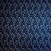 Dark blue lace fabric on a white background.