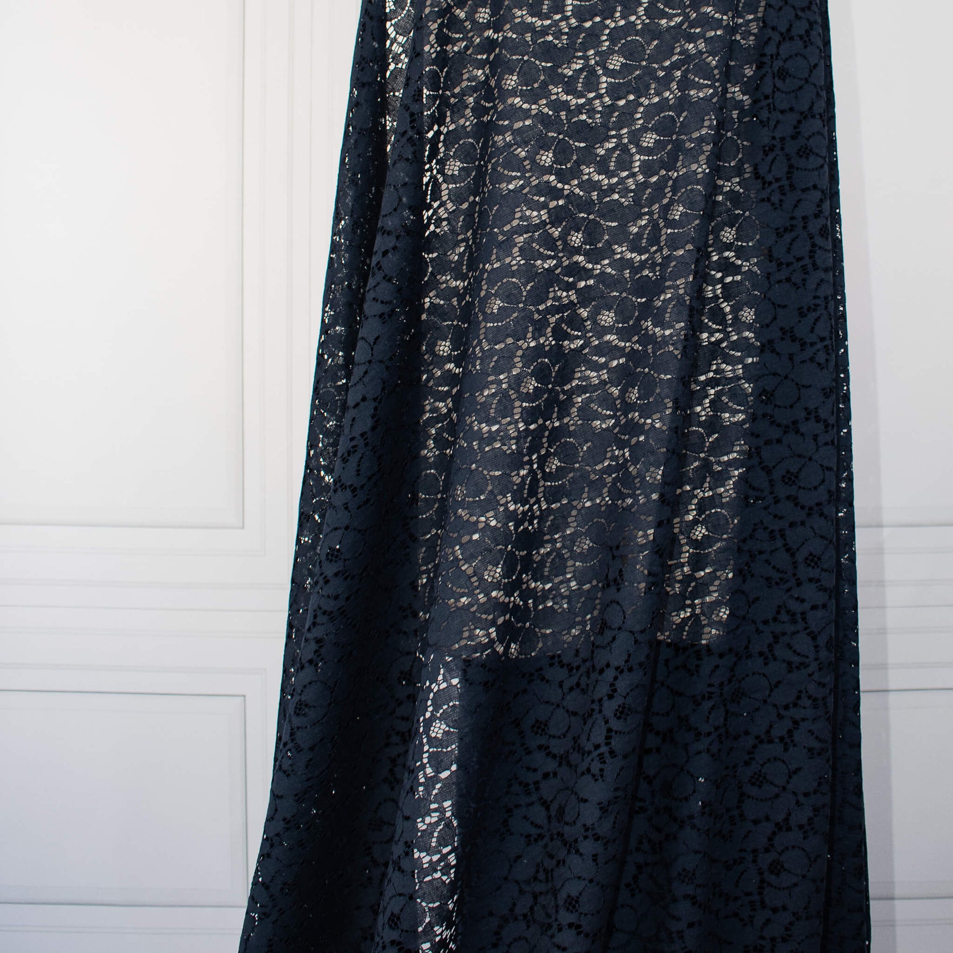 Blue lace Designer fabric draped on dressform.  