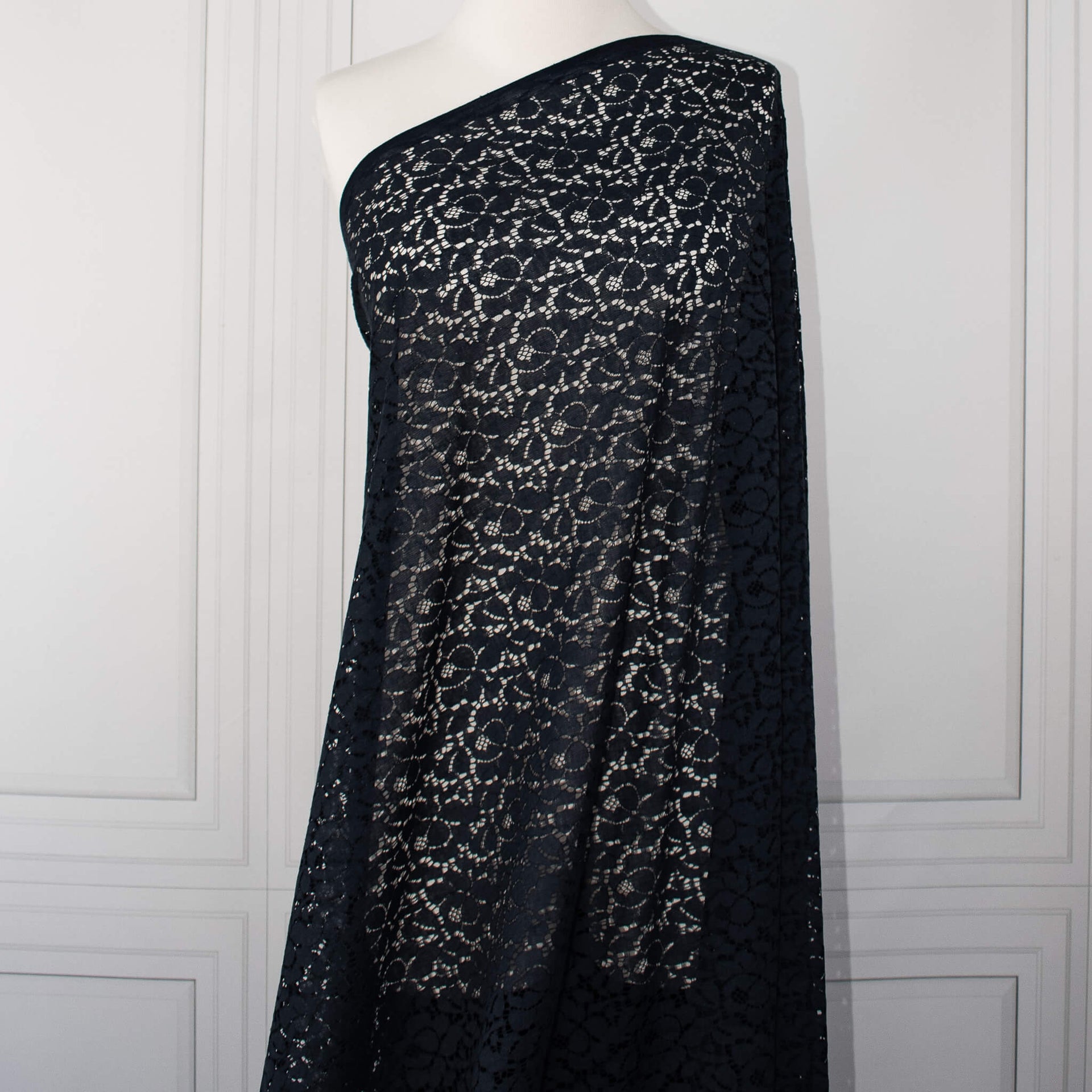 Blue lace Designer fabric draped on dressform.  