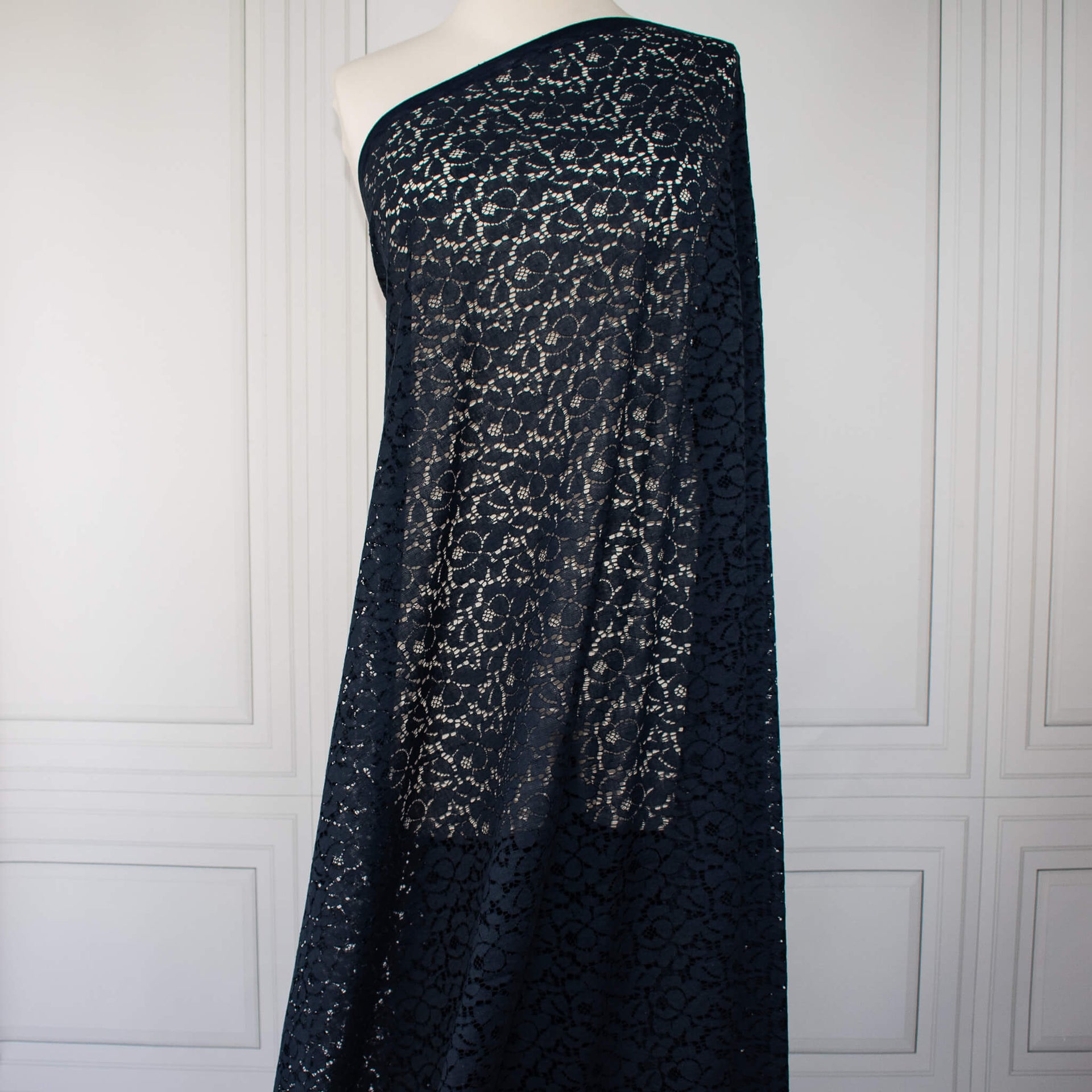 Blue lace Designer fabric draped on dressform.  