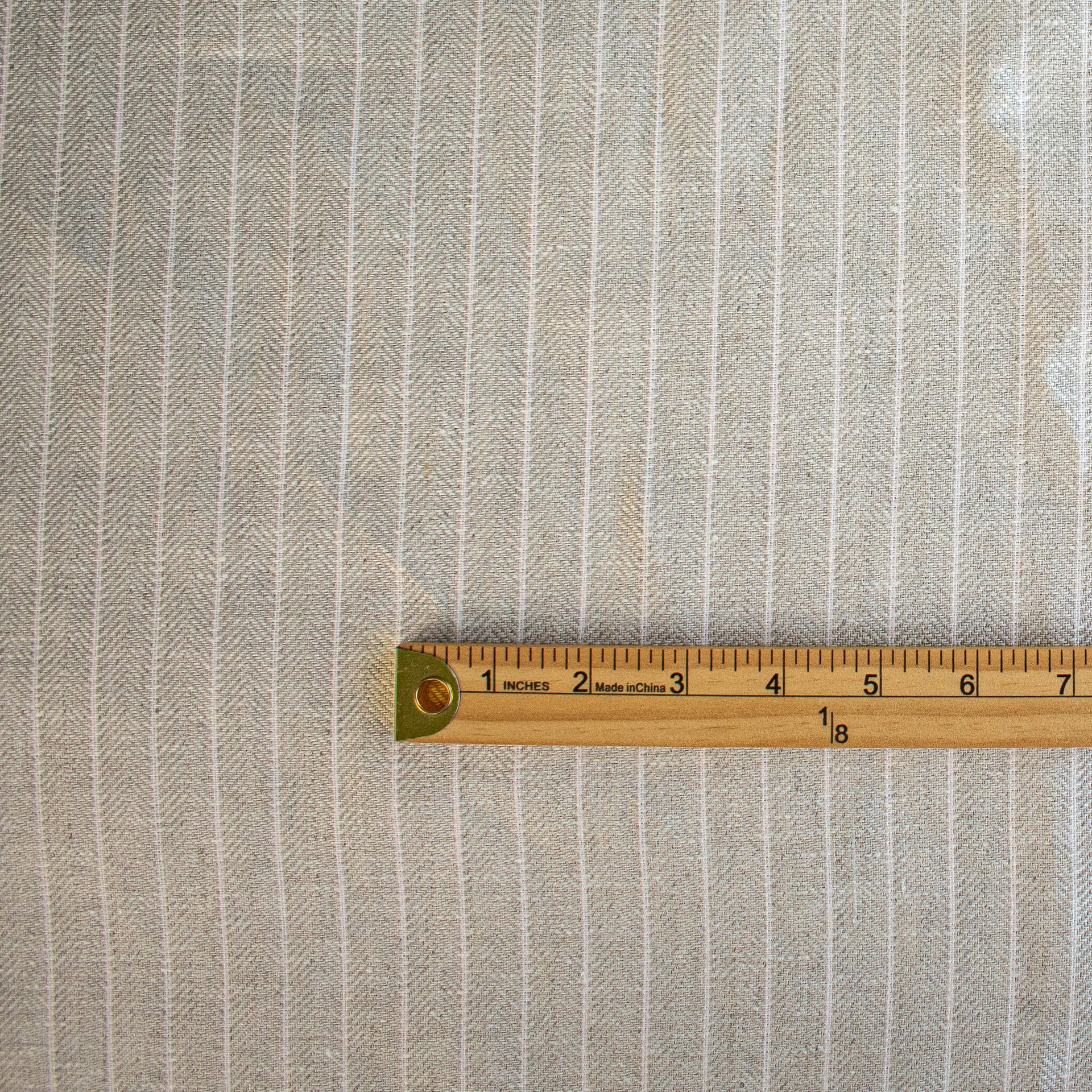 European Mid-Weight 100% Linen Stripe Herringbone Weave fabric with ruler for scale.