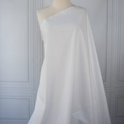 White NYC designer shirting fabric draped over a dressform