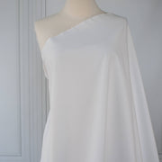 White NYC designer shirting fabric draped over a dressform