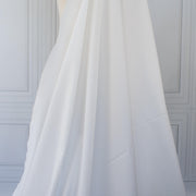 White NYC designer shirting fabric draped over a dressform