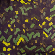 A close-up of a patterned fabric featuring abstract, hand-painted style brushstrokes in green, bright yellow, and dark brown on a deep purple background.