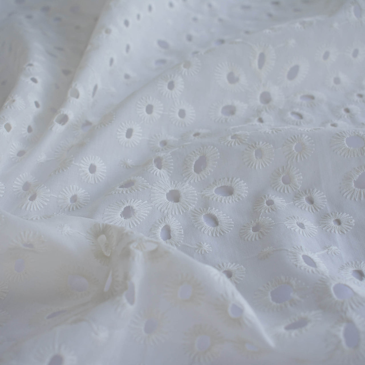 Image of  Italian Cotton San Gallo Lace in soft white, a delicate broderie anglaise fabric by the yard. 