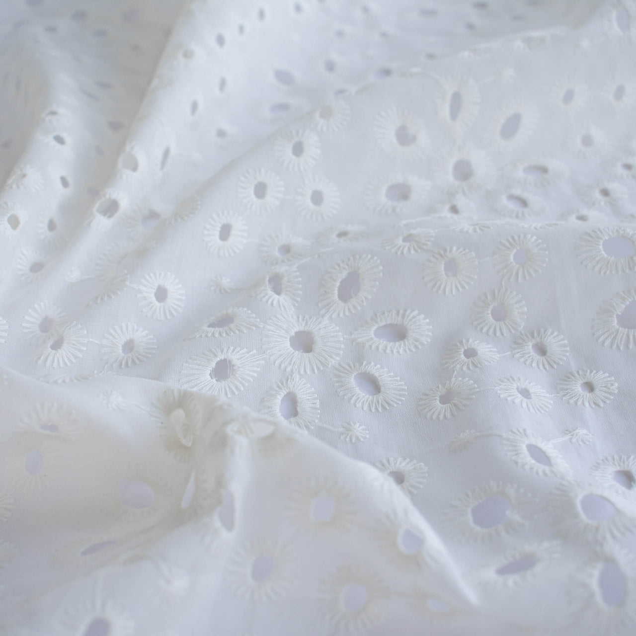 Image of  Italian Cotton San Gallo Lace in soft white, a delicate broderie anglaise fabric by the yard. 
