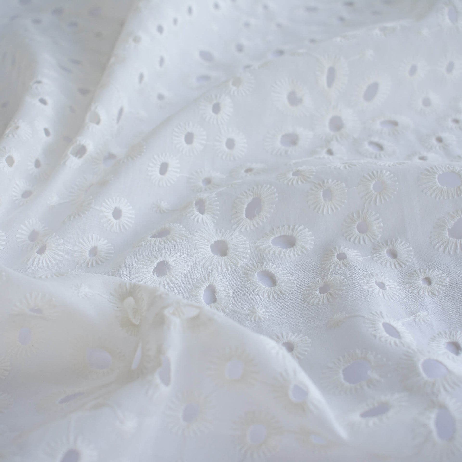 Image of  Italian Cotton San Gallo Lace in soft white, a delicate broderie anglaise fabric by the yard. 