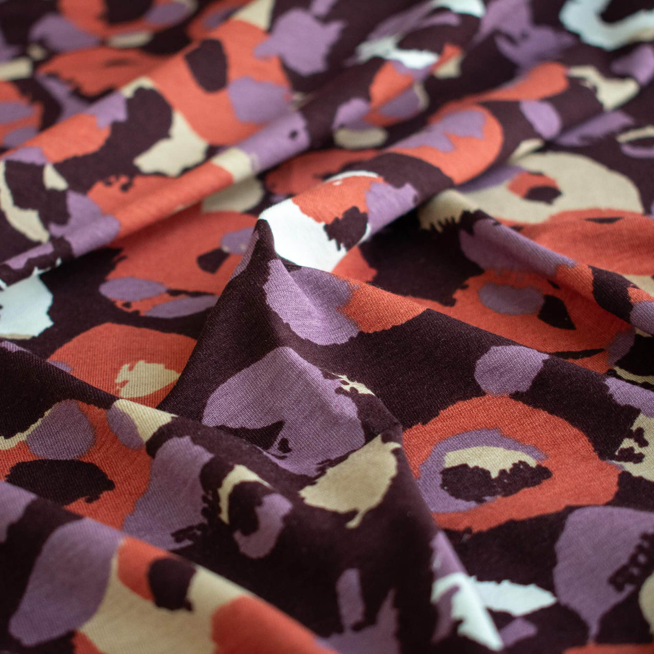 A close-up of Italian Cotton Jersey Warm Abstract Print fabric by the yard