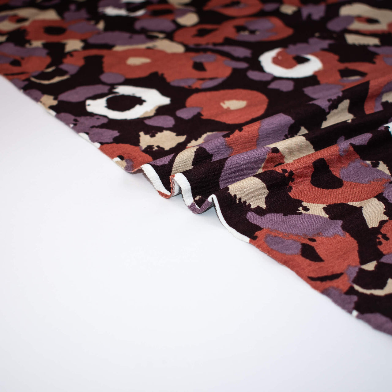 image of Italian Cotton Jersey Warm Abstract Print fabric selvedge