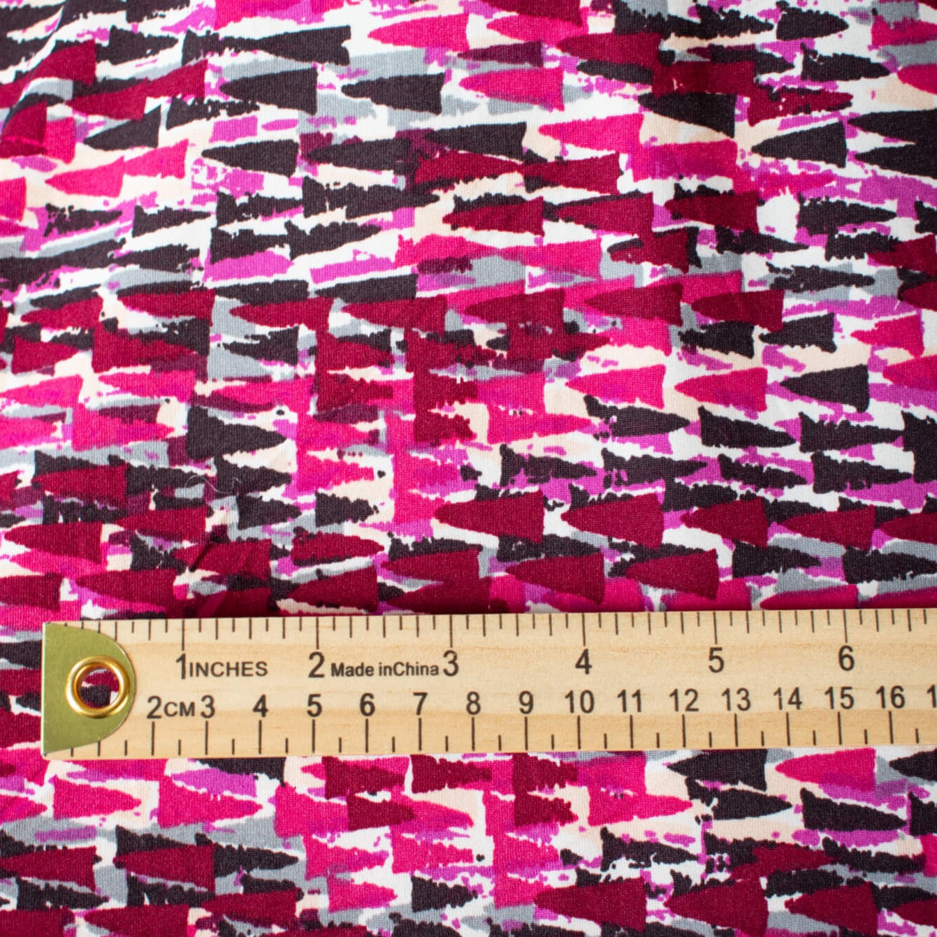 Modern and fabulous, that's how you'll look in this abstract DTY print.  Perfect for a wrap dress or top that is pure sophistication!  DTY is a double twisted yard which is not as thin as an ITY knit.  It has a soft touch, drapes nicely, and is easy to sew. Close up image of fabric pattern scale with ruler.