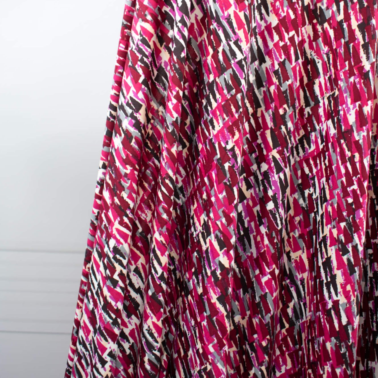 Modern and fabulous, that's how you'll look in this abstract DTY print.  Perfect for a wrap dress or top that is pure sophistication!  DTY is a double twisted yard which is not as thin as an ITY knit.  It has a soft touch, drapes nicely, and is easy to sew. Image of fabric drape.