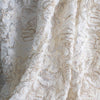 Couture specialty lace from a Beverly Hills couture designer is so soft, as if spun on air. Sheer petals are contained in spun gold and silver metallic threads. Photo shows fabric drape.
