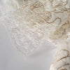 Couture specialty lace from a Beverly Hills couture designer is so soft, as if spun on air. Sheer petals are contained in spun gold and silver metallic threads. Photos shows weblike selvedge.