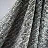 Close up of black and white jacquard fabric by the yard. Subtle silver metallic threads through out this wool blend suiting. Imported from France. Perfect for that Classic French Jacket! - image shows fabric drape