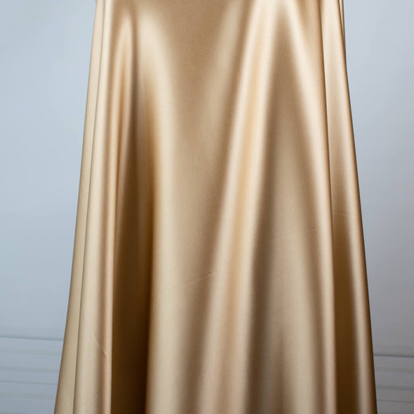 Feel special with a bit of "Shimmer"!  Our designer silk charmeuse in a lovely honey color with a hint of stretch will fancy up your outfit!  Create a gorgeous charmeuse camisole top or go for the popular bias-cut dress or skirt.  And don’t forget, that bit of stretch is perfect if you are lining a French Jacket or just want a bit of extra comfort in your silk. Image of fabric drape.
