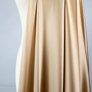 Feel special with a bit of "Shimmer"!  Our designer silk charmeuse in a lovely honey color with a hint of stretch will fancy up your outfit!  Create a gorgeous charmeuse camisole top or go for the popular bias-cut dress or skirt.  And don’t forget, that bit of stretch is perfect if you are lining a French Jacket or just want a bit of extra comfort in your silk. Image of fabric drape.