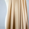 Feel special with a bit of "Shimmer"!  Our designer silk charmeuse in a lovely honey color with a hint of stretch will fancy up your outfit!  Create a gorgeous charmeuse camisole top or go for the popular bias-cut dress or skirt.  And don’t forget, that bit of stretch is perfect if you are lining a French Jacket or just want a bit of extra comfort in your silk. Image of fabric drape.