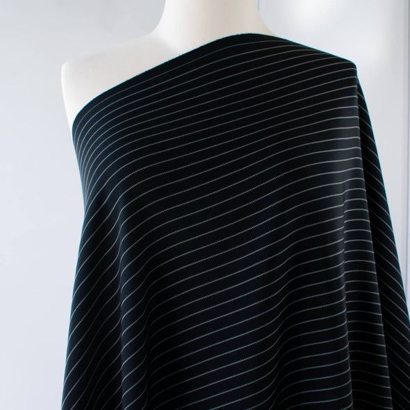 Gorgeous Couture Designer 4-Ply Silk Black with a white vertical double pinstripe, this premium medium weight silk has a soft sheen and gentle drape. A fine smooth hand feels buttery on the skin, perfect for a wide leg pant, vest, jacket or dress! Image of fabric draped on dressform