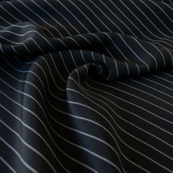 Gorgeous Couture Designer 4-Ply Silk Black with a white vertical double pinstripe, this premium medium weight silk has a soft sheen and gentle drape. A fine smooth hand feels buttery on the skin, perfect for a wide leg pant, vest, jacket or dress! Image of fabric.