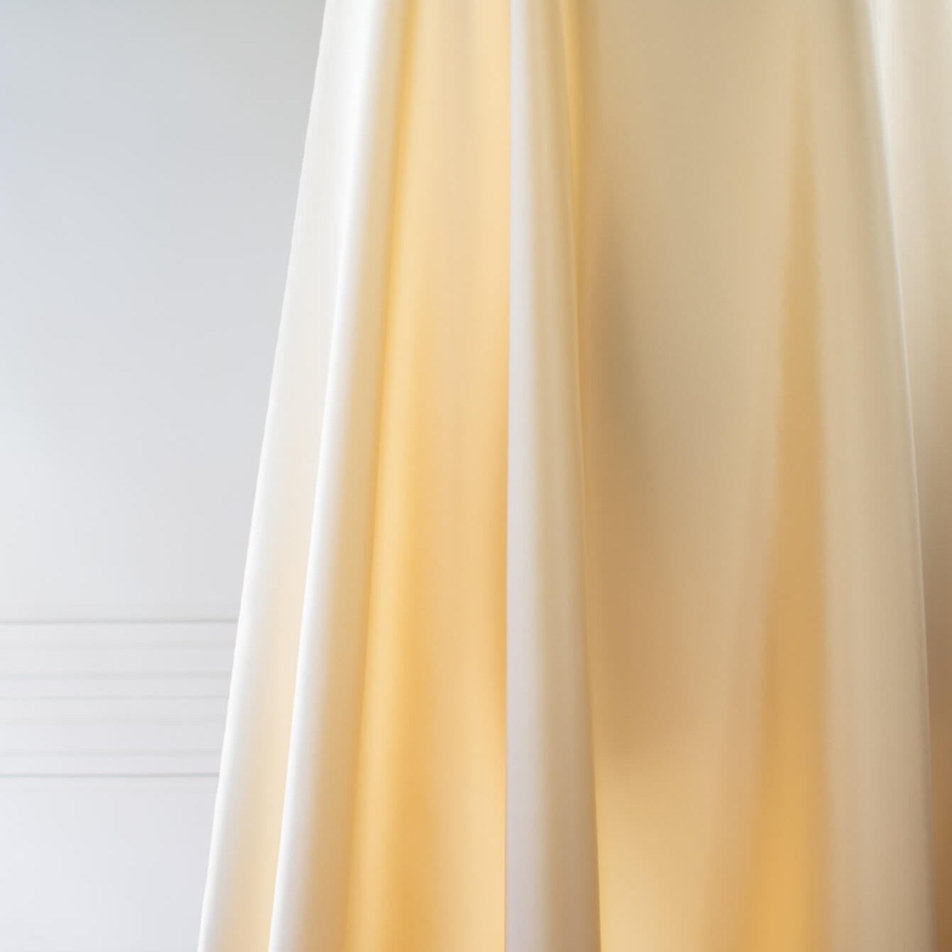 Couture Designer 4-Ply Silk in an ivory buttercream is a premium medium weight silk and is so glamorous! Luxurious and elegant with a soft sheen and gentle drape. A fine smooth hand feels buttery on the skin, perfect for draped, fitted, or fuller styles perhaps a wide leg pant, vest, jacket, or dress!  Image of fabric drape.