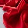 Enjoy the luxury of stretch silk charmeuse in scarlet. Designer deadstock originally from a New York couture designer! You can enjoy the silkiness of a 96 % silk and 4% lycra in a easy to work with 54 inch width for one of your fancy frocks. A popular fabric for creating fluid bias cut garments and luxurious lining to your special pieces like the French Jacket. Photo of fabric selvedge.