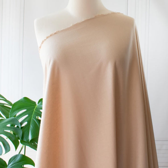 LA Designer silk noil in a soft creamy ecru. A nice fabric for tailored and loose-fitting styles!  Perfect for a wide-leg  pant, or a tailored shirt dress or casual jacket.   Image of fabric drape on dressform