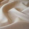 LA Designer silk noil in a soft creamy ecru. A nice fabric for tailored and loose-fitting styles!  Perfect for a wide-leg  pant, or a tailored shirt dress or casual jacket.   Close up image