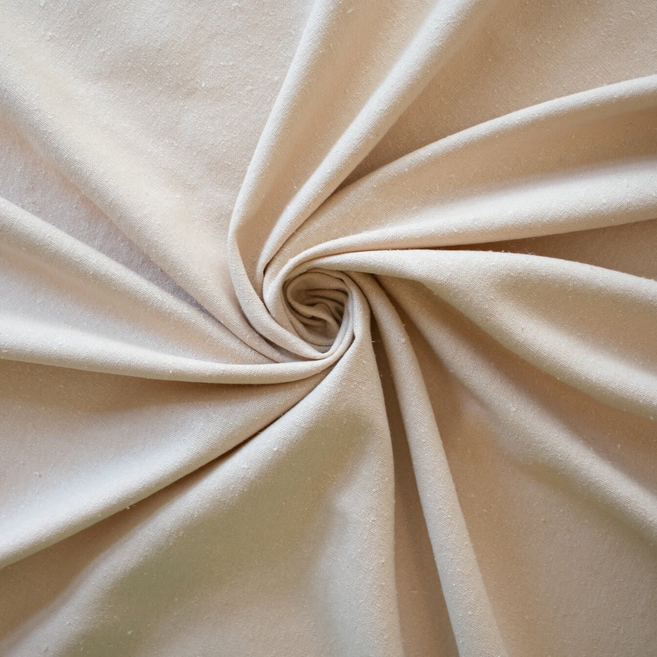 LA Designer silk noil in a soft creamy ecru. A nice fabric for tailored and loose-fitting styles!  Perfect for a wide-leg  pant, or a tailored shirt dress or casual jacket.  Image of fabric body.