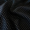 Luxurious designer suiting in black with a white and gold metallic running stitch. Take sophistication up a notch in this gorgeous wool blend with a soft and supple hand. Perfect for a glamorous tailored suit or jacket. close up image