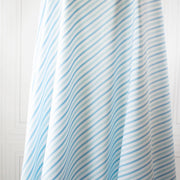 Designer striped cotton shirting that is soft, silky and "Fresh as Air"! White, powder blue and sky blue woven vertical stripes will bring a freshness to your style. Perfect for summer dresses, the classic shirtdress, a classic tailored shirt, or tunic. Image of fabric draped on dress form displaying soft cones away from body.