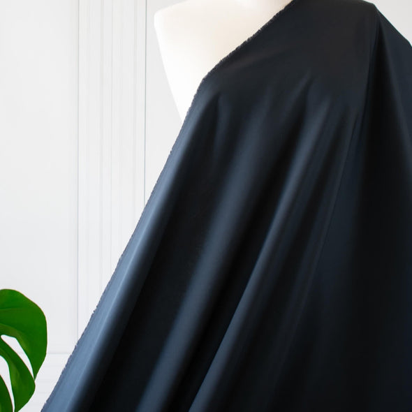 Curated from a LA design house which specializes in luxurious minimalist fashion, this cotton suiting will have you feeling sophisticated and confident.  Create your own little black dress for Spring and Summer! image of fabric drape