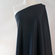 Transform this high-end designer Ponte knit into pure fabulous.  Whether you have a little black dress in mind, a pencil skirt, or jacket you'll exude confidence and sophistication when you walk in the room. You'll love the soft touch of the fabric and the comfort of it's stretch. Image of fabric on dressform .