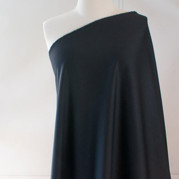 Transform this high-end designer Ponte knit into pure fabulous.  Whether you have a little black dress in mind, a pencil skirt, or jacket you'll exude confidence and sophistication when you walk in the room. You'll love the soft touch of the fabric and the comfort of it's stretch. Image of fabric on dressform .